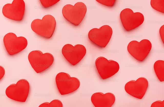 Vista plana de corazones de San Valentín sobre fondo rosa - Banco de imágenes católicas - Fotografía por Antonio Gravante