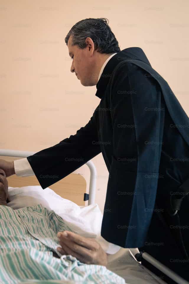 Priest Anointing of the Sick - Catholic stock images