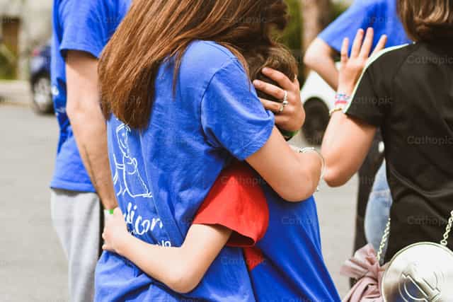 A warm embrace between mother and son - Catholic stock images - Photo by Samuel Rufini
