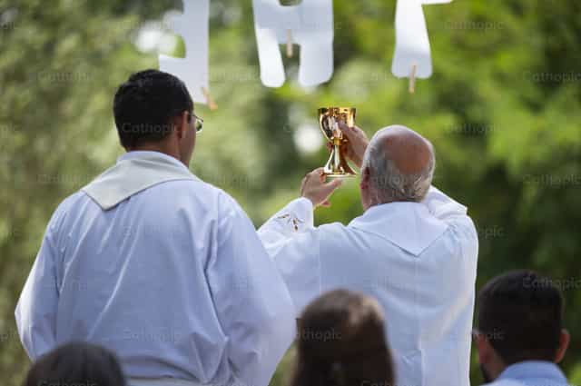 Sacerdote che celebra la Santa Messa. Consacrazione - Immagini stock cattoliche