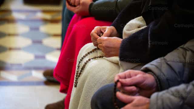 Hands holding the rosary - Catholic stock images