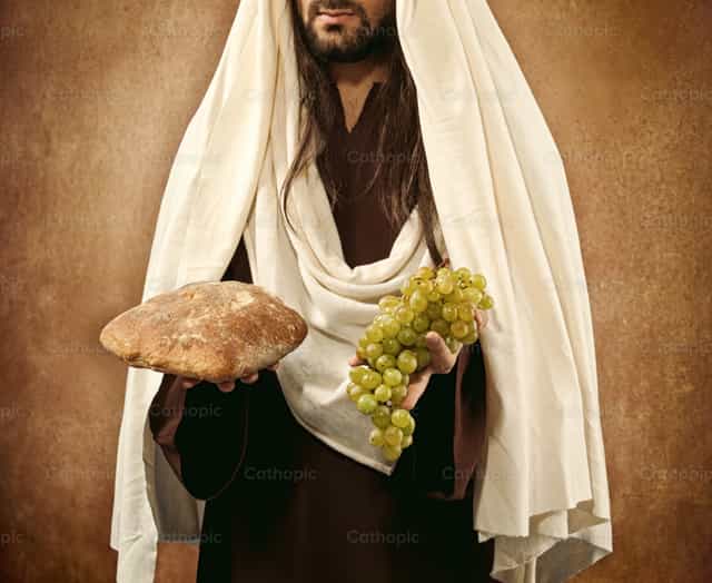 Jésus donne du pain et des raisins - Images catholiques de stock