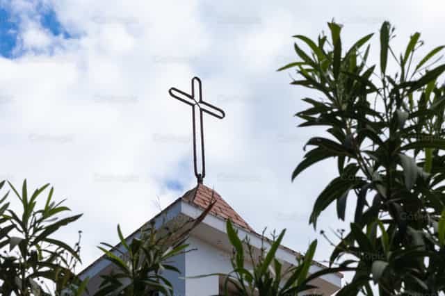 Cruz de hierro sobre el tejado de una iglesia - Banco de imágenes católicas - Fotografía por Antonio Gravante