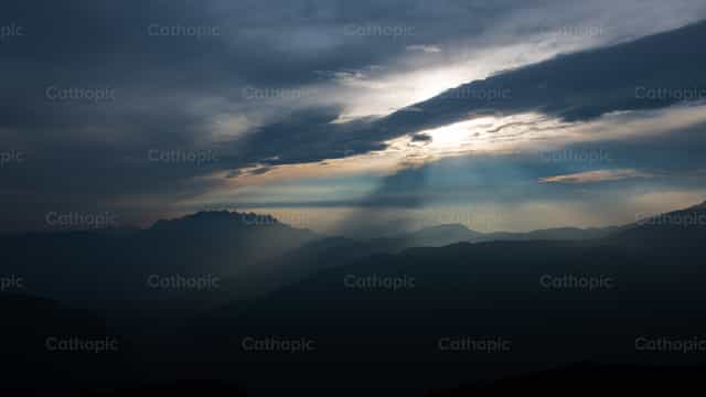 Mountain landscape with sunbeams breaking through - Catholic stock images