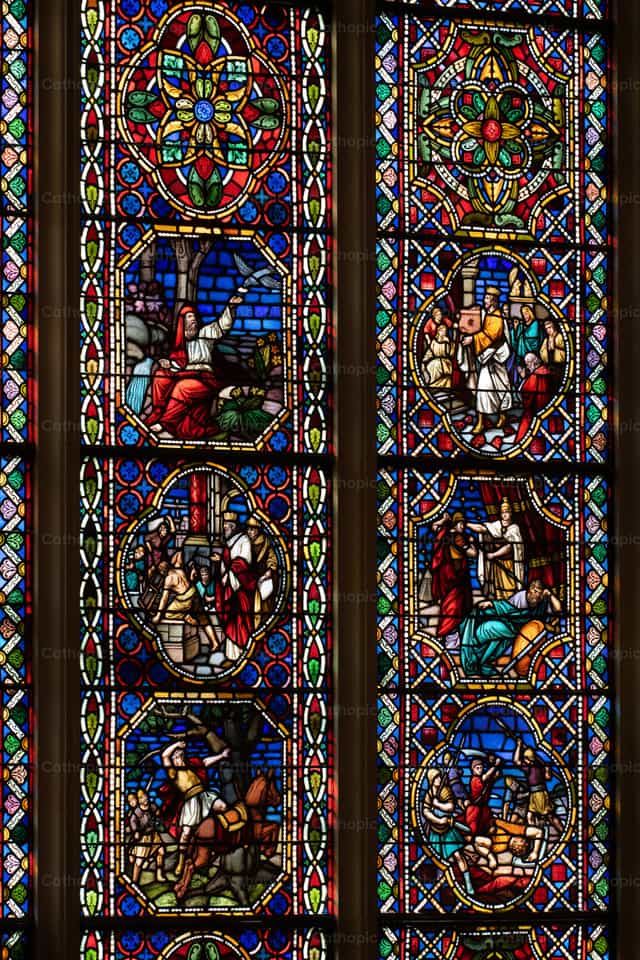 Stained glass with Biblical scenes - Catholic stock images - Photo by Coffee With Damian