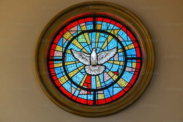 Circular stained glass window with mosaic of the Holy Spirit, vibrant ...