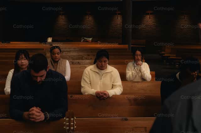 Young people praying in a multicultural meeting - Catholic Stock Images
